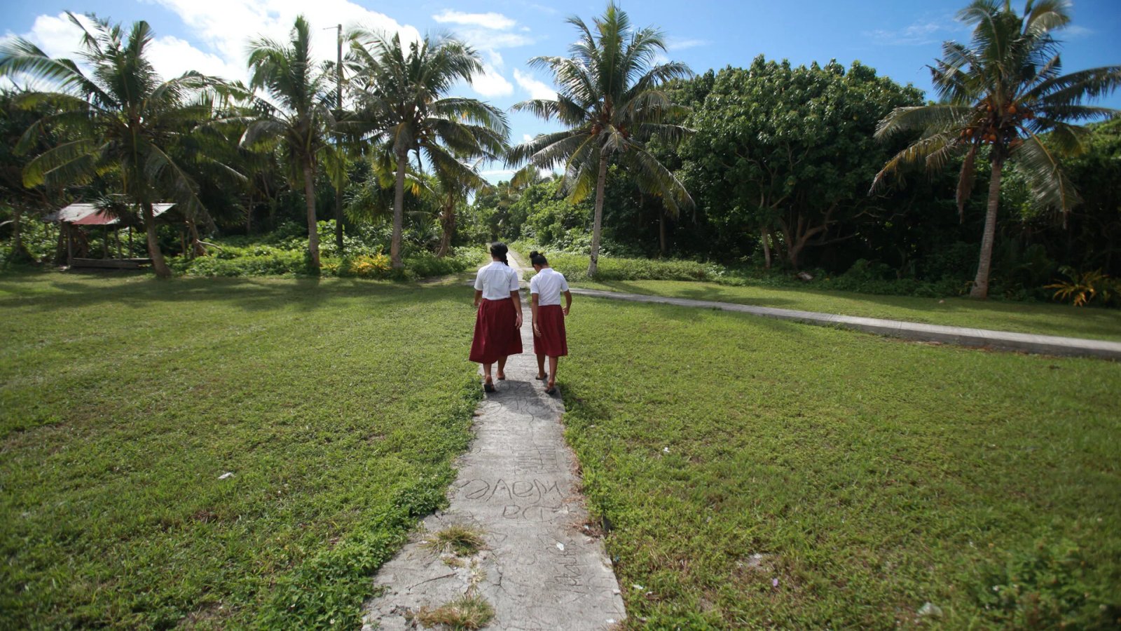 Children walk towards the ancient jungle / forest where rare medicinal plant are in abundance.