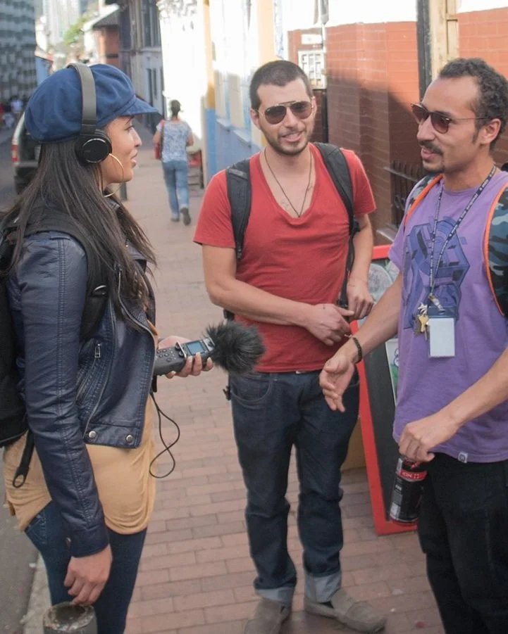 Queen conducting interviews with local artists in Bogotá for the United Nations-funded short film "WaronUS," which was filmed entirely in the South American country of Colombia.
