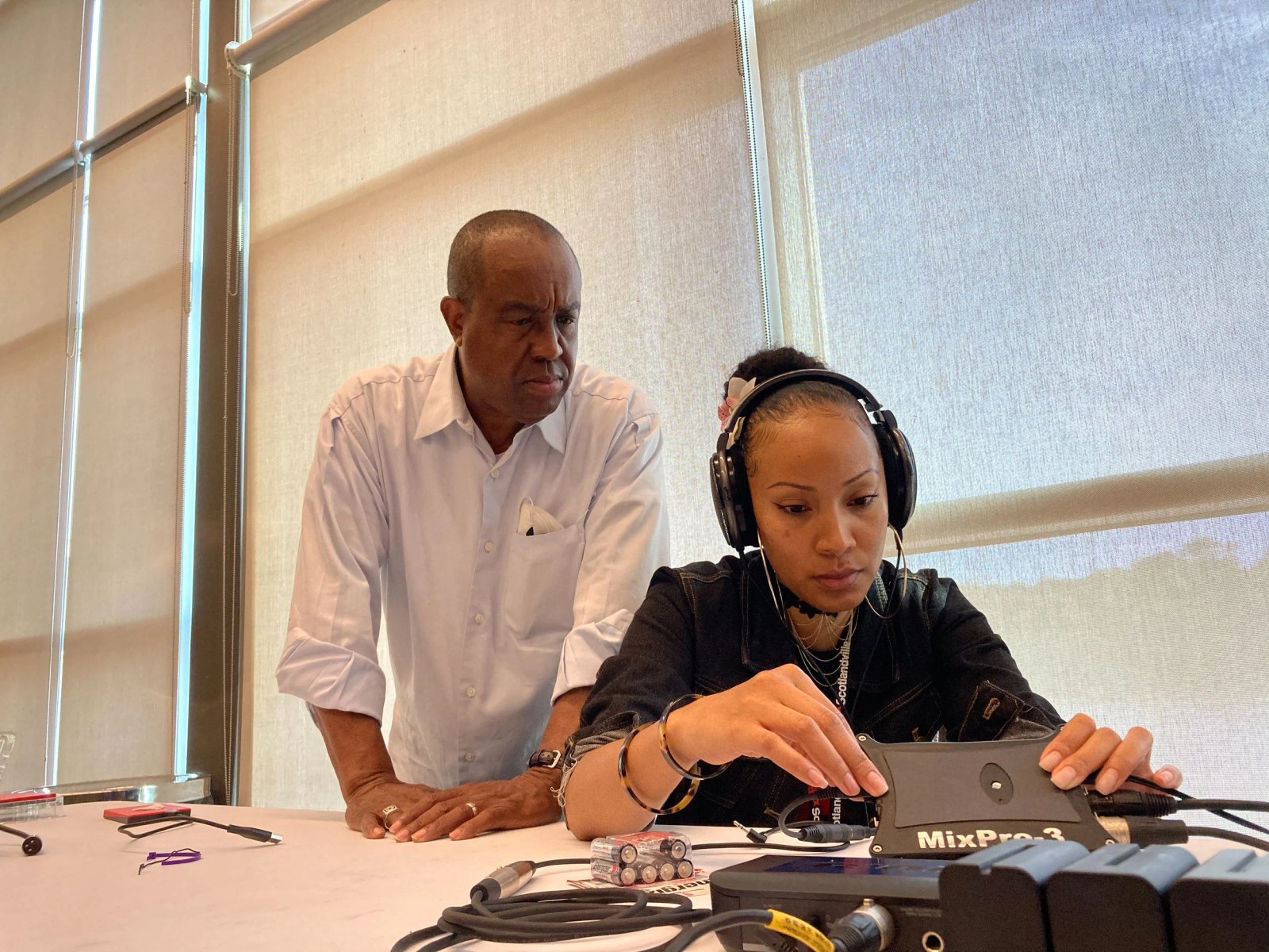 Ademah’s apprentice Masaniai checks the levels on the digital sound recorder