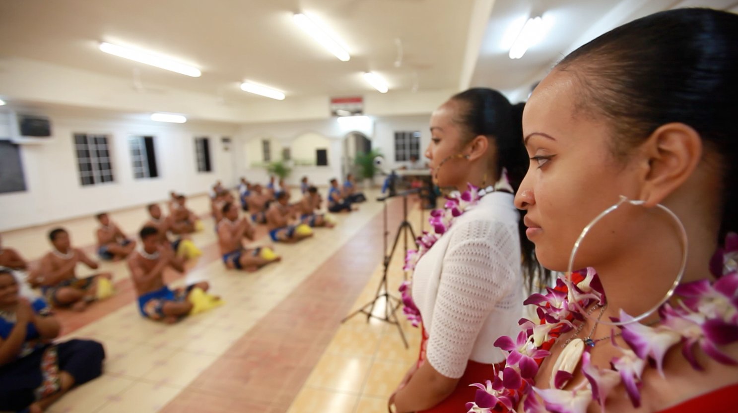 The village children honor Queen and her sister with traditional dances.